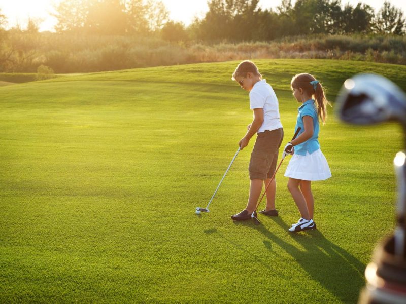 bigstock-Casual-Kids-At-A-Golf-Field-Ho-79961312